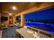 Inviting outdoor patio with a dining table, comfortable seating, and a view of the pool and city lights at 11248 Rebel Dome Ct, Las Vegas, NV 89141