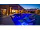 Gorgeous backyard pool with illuminated water features, in-pool loungers, and views of the home at 11248 Rebel Dome Ct, Las Vegas, NV 89141