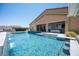 Backyard pool featuring a rock waterfall, seamless integration with the patio, and a clear view of the hillside at 11248 Rebel Dome Ct, Las Vegas, NV 89141