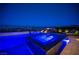 Inviting pool and jacuzzi featuring illuminated water features, set against a twilight cityscape backdrop at 11248 Rebel Dome Ct, Las Vegas, NV 89141