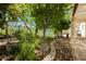 Backyard showcases lush landscaping, stone pathways, and wrought iron fencing at 1311 Rolling Sunset St, Henderson, NV 89052