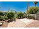 View of the backyard with decorative white cross pattern on patio with wrought iron and block wall perimeter at 1311 Rolling Sunset St, Henderson, NV 89052