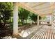 Backyard covered patio features white columns and lush landscaping, a peaceful retreat at 1311 Rolling Sunset St, Henderson, NV 89052