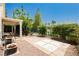 Charming backyard patio features stone pavers, a pergola, and lush landscaping at 1311 Rolling Sunset St, Henderson, NV 89052