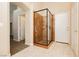 Modern bathroom with a framed glass shower and neutral tiling, offering a sleek design at 1311 Rolling Sunset St, Henderson, NV 89052