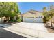 Lovely single-story home featuring a two-car garage and mature landscaping at 1311 Rolling Sunset St, Henderson, NV 89052