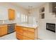 Well-lit kitchen boasts stainless steel appliances and beautiful granite countertops at 1311 Rolling Sunset St, Henderson, NV 89052