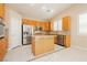 Traditional kitchen featuring wood cabinets, stainless steel appliances, and tile flooring at 1311 Rolling Sunset St, Henderson, NV 89052