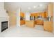 Open kitchen features light wood cabinets, stainless steel appliances, and a center island at 1311 Rolling Sunset St, Henderson, NV 89052
