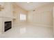 Bright living room featuring a fireplace, neutral tones, and tile flooring at 1311 Rolling Sunset St, Henderson, NV 89052