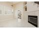 Living room has high ceilings, fireplace, plantation shutters, and a sliding glass door at 1311 Rolling Sunset St, Henderson, NV 89052