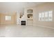 Bright living room featuring fireplace, neutral tones, and tile flooring at 1311 Rolling Sunset St, Henderson, NV 89052