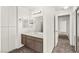Bright bathroom with a brown vanity, white countertops, and updated lighting fixtures at 1405 Wintergreen Dr, Las Vegas, NV 89128