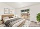 Cozy bedroom with neutral decor, sliding glass door to outdoor patio, and ample natural light at 1405 Wintergreen Dr, Las Vegas, NV 89128