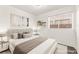 Staged bedroom featuring a plush bed and a bright window at 1405 Wintergreen Dr, Las Vegas, NV 89128