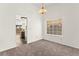 Empty dining room with carpet, a window and an adjacent view into the kitchen at 1405 Wintergreen Dr, Las Vegas, NV 89128