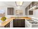 Cozy kitchen with butcher block countertops, stainless steel sink and white appliances at 1405 Wintergreen Dr, Las Vegas, NV 89128