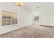 Unfurnished living area with large windows, carpet and a view of the neighborhood at 1405 Wintergreen Dr, Las Vegas, NV 89128