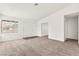 Spacious living area with neutral carpet, ample natural light, and multiple entryways at 1405 Wintergreen Dr, Las Vegas, NV 89128