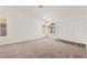 Bright, vacant living room with large windows, neutral carpet, and well-lit interior at 1405 Wintergreen Dr, Las Vegas, NV 89128