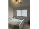 Bright bedroom featuring neutral walls, carpet flooring, and a comfortable queen size bed at 1512 Couples St, Las Vegas, NV 89128