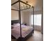 Bedroom with a bed frame, side table and natural light from the windows at 1512 Couples St, Las Vegas, NV 89128