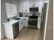 Modern kitchen featuring white cabinets and stainless steel appliances at 1512 Couples St, Las Vegas, NV 89128