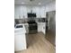 Well-lit kitchen boasts stainless steel appliances and white cabinets at 1512 Couples St, Las Vegas, NV 89128