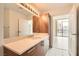 Bathroom with a vanity, large mirror, and doorway to the bedroom at 200 W Sahara Ave # 1102, Las Vegas, NV 89102
