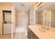 Bathroom features a combined washer/dryer, tub, and vanity area at 200 W Sahara Ave # 1102, Las Vegas, NV 89102