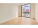 Modern bedroom with light wood floors and a large window with city views at 200 W Sahara Ave # 1102, Las Vegas, NV 89102
