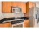 Modern kitchen with stainless steel appliances, granite countertops, and wood cabinetry at 200 W Sahara Ave # 1102, Las Vegas, NV 89102