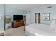 Bright bedroom featuring light blue walls, television, modern dresser, and views through doorways at 2000 Fashion Show Dr # 6109, Las Vegas, NV 89109