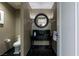 Stylish powder room featuring a modern vanity, round mirror, elegant lighting, and sophisticated black marble flooring at 2000 Fashion Show Dr # 6109, Las Vegas, NV 89109