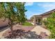 Landscaped backyard with a covered patio, artificial grass, desert plants, and a stone pathway at 2144 Mountain City St, Henderson, NV 89052