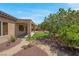 Backyard featuring mature trees, well-maintained landscaping, and desert landscape at 2144 Mountain City St, Henderson, NV 89052