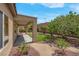 Backyard featuring lush trees, well-maintained landscaping, and a covered patio area at 2144 Mountain City St, Henderson, NV 89052