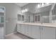 Bathroom with double sink vanity, large mirror, and a view of the shower and bedroom at 2144 Mountain City St, Henderson, NV 89052