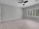 Spacious bedroom features sleek flooring, a ceiling fan, and bright natural light from large windows at 2144 Mountain City St, Henderson, NV 89052