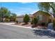Street view of a single-story home with a manicured yard and three-car garage at 2144 Mountain City St, Henderson, NV 89052