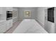 Kitchen island with quartz countertop and stainless steel refrigerator at 2144 Mountain City St, Henderson, NV 89052