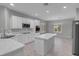 Bright, open kitchen features white cabinets, stone countertops, and stainless steel appliances at 2144 Mountain City St, Henderson, NV 89052