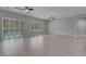 Bright living room featuring wood floors, neutral paint, and sliding glass doors with plantation shutters at 2144 Mountain City St, Henderson, NV 89052