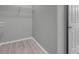 Neutral walk-in closet with hanging racks and sleek flooring, maximizing storage and functionality at 2144 Mountain City St, Henderson, NV 89052