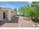 Spacious backyard features desert landscaping, a covered patio, and views of the surrounding area at 2292 Saxtons River Rd, Henderson, NV 89044