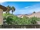 Scenic backyard view with lush greenery, mountain vistas, and glimpses of nearby rooftops at 2292 Saxtons River Rd, Henderson, NV 89044