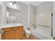 Bright bathroom features a combination tub and shower, neutral tile and ample cabinet space at 2292 Saxtons River Rd, Henderson, NV 89044