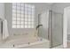 Bathroom featuring shower, soaking tub, and glass block window at 2292 Saxtons River Rd, Henderson, NV 89044