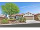 Charming single-story home featuring a well-manicured lawn, desert landscaping, and a two-car garage at 2292 Saxtons River Rd, Henderson, NV 89044