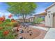 Beautiful home with desert landscaping, colorful flowers, and a paved walkway leading to the front door at 2292 Saxtons River Rd, Henderson, NV 89044